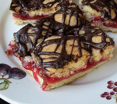 A close up photo of cherry pie squares on a white plate.