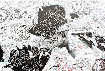 A Michael Jackson mural covered with fan's signatures stands in front of the Staples Center