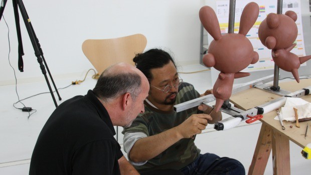 Murakami and Macy's designer John Piper inspects the balloon maquette at Kaikai Kiki's Miyoshi studio in Saitama, Japan.