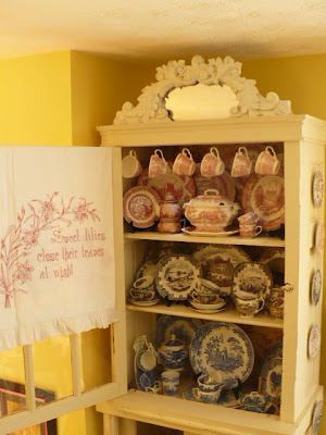 transferware dishes in a china cabinet