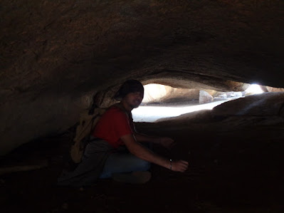 hiker sitting in the caves at the summit of nijagal betta trek