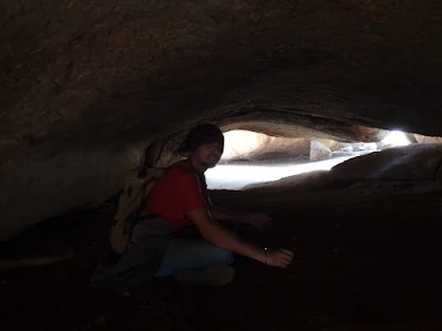 hiker sitting in the caves at the summit of nijagal betta trek