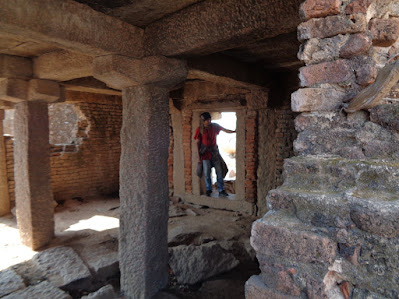 Hiker exploring the the lost ruined buildings at the nijagal betta trek