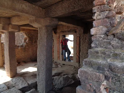 Hiker exploring the the lost ruined buildings at the nijagal betta trek