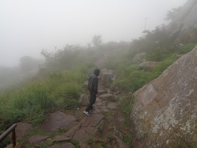 hiker cautiously treks down into the flat land at shivagange