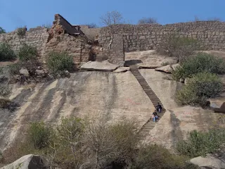 Hiker rests on steps leading to the summit of Ratnagiri fort hill in Andhra Pradesh