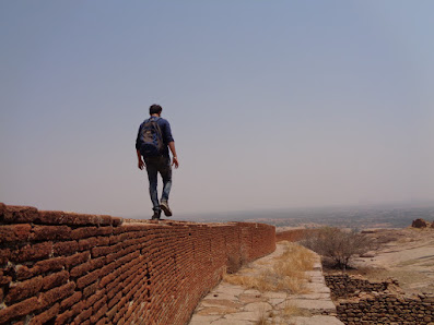 Deefu walking on the top most fort wall on the summit at bhasmangi