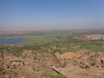 Sippy standing on a rock overseeing the entire landscape of Pandavpura