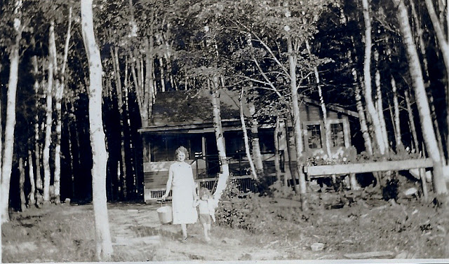 Woman and child at camp, date unknown
