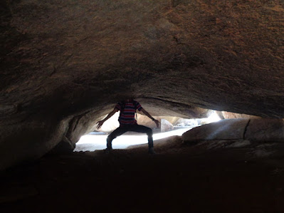 hiker pretending to be a headless chicken in dark caves at the summit of nijagal betta