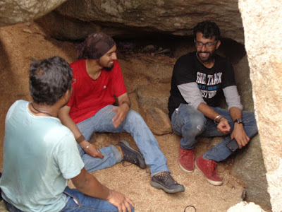 Hikers sitting in the cave at the summit and discussing funny incidents