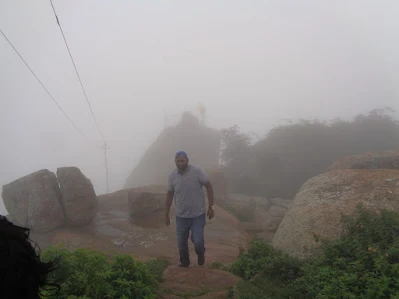 hiker treks through the fog at the final stretch at shivagange