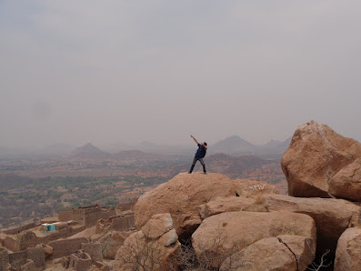 Hiker poses at the summit of the madakasira fort trek