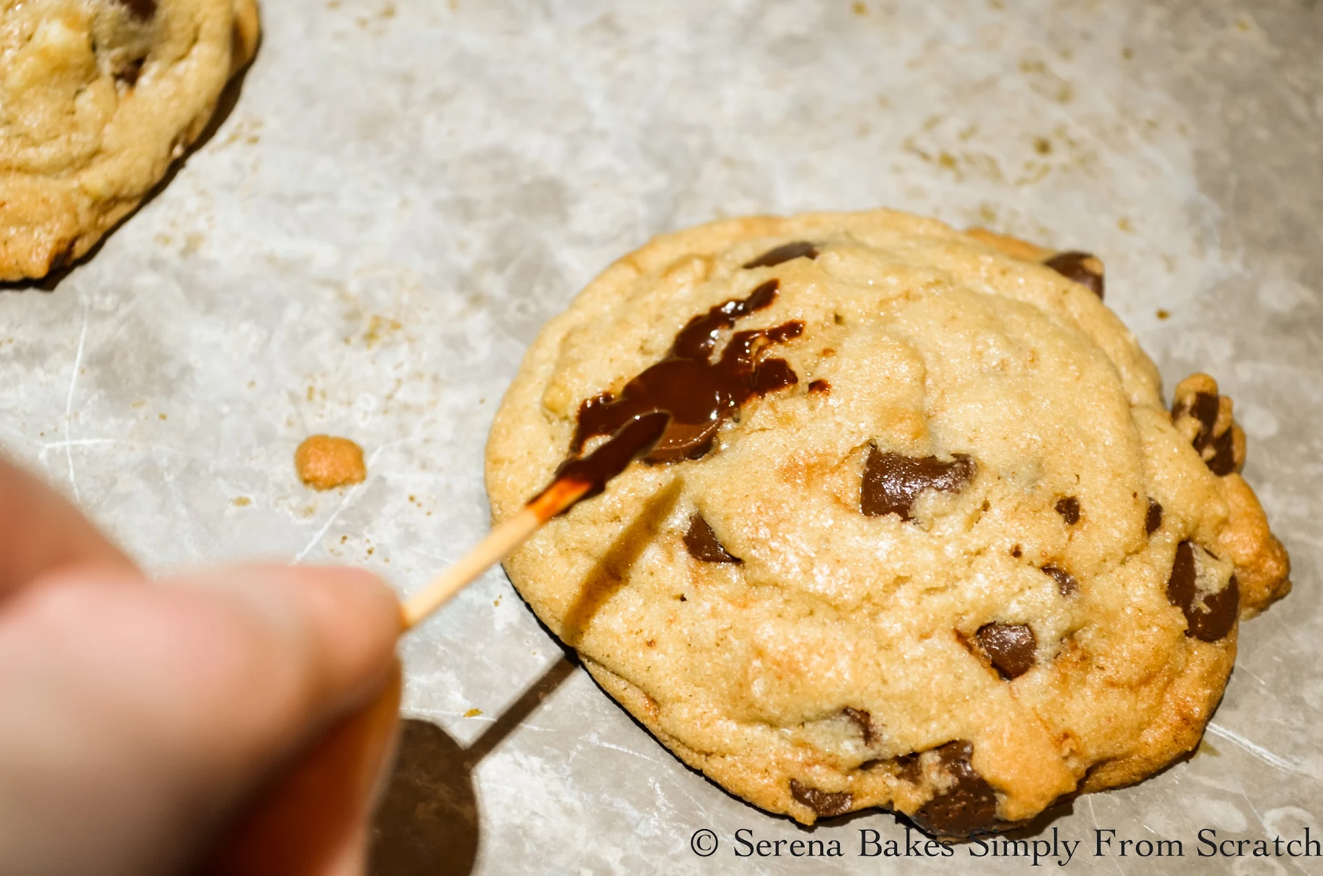 Use a toothpick to draw on legs for Spider Chocolate Chip Cookies.